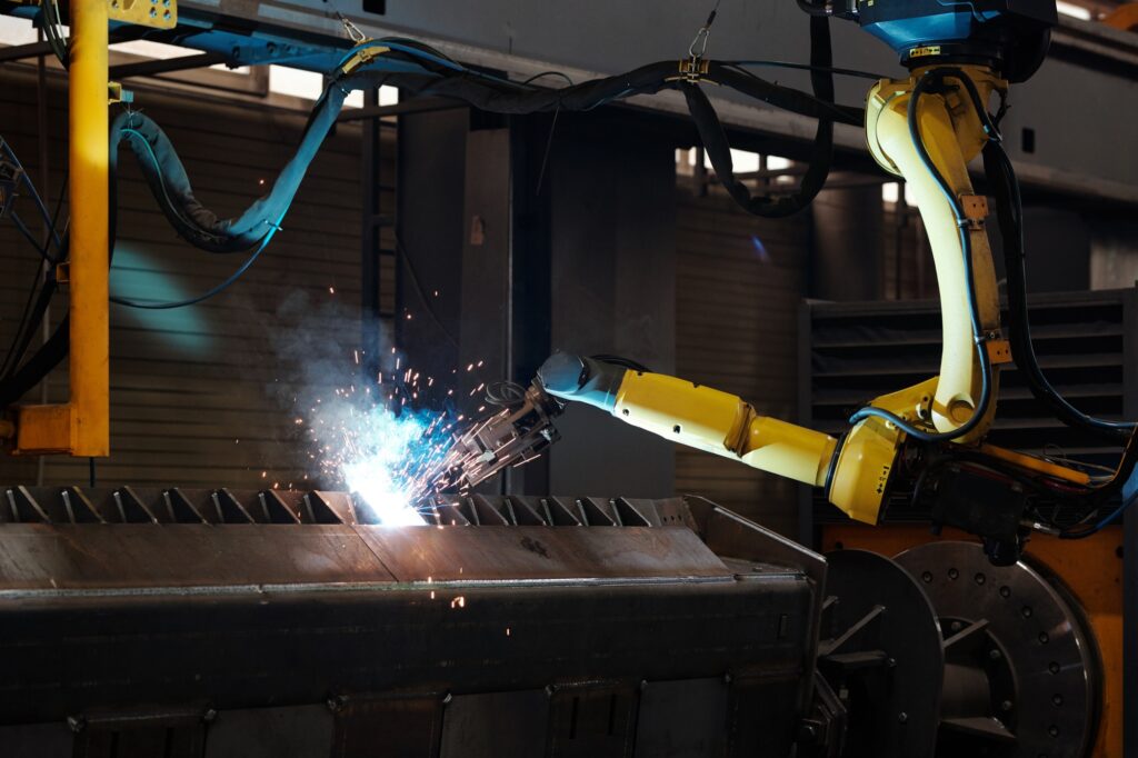Arc welding of huge industrial machine during process of repairing